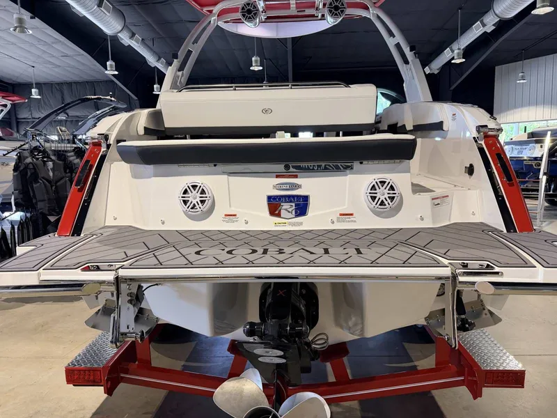 Slide: The Image of Rear view of a 2025 Cobalt R6 boat in showroom. - 27
