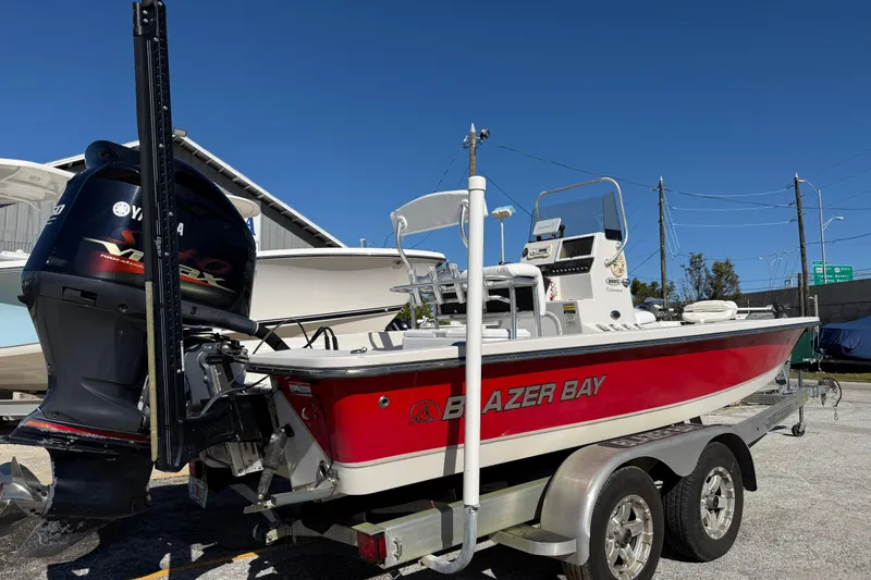 Slide: The Image of 2017 Blazer Bay 2220 Fisherman boat on trailer with Yamaha engine, parked outdoors. - 4