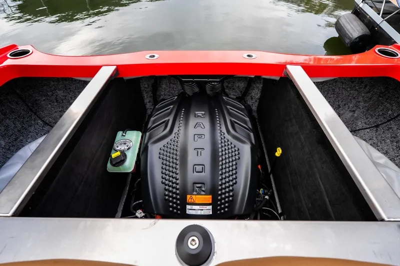 Slide: The Image of Storage compartment of 2026 MB B52 23 Classic boat with gray fabric and red trim. - 12