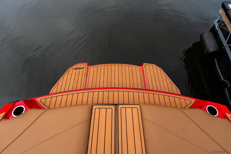 Slide: The Image of 2026 MB B52 23 Classic boat in vibrant red on a trailer, displayed indoors. - 2