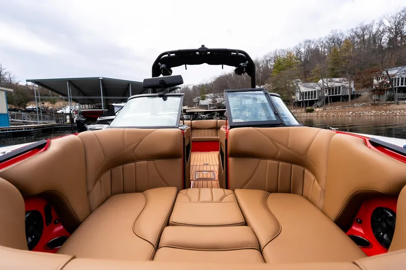 Slide: The Image of 2026 MB B52 23 Classic boat docked, featuring red exterior and tan interior seating. - 25