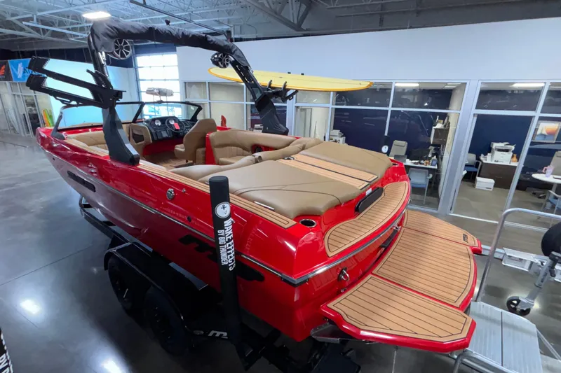 Slide: The Image of Red 2026 MB B52 23 Classic boat with surfboard, displayed indoors on a trailer. - 37