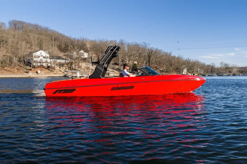 Slide: The Image of 2026 MB B52 23 Classic boat, red exterior, tan interior, displayed indoors. - 38