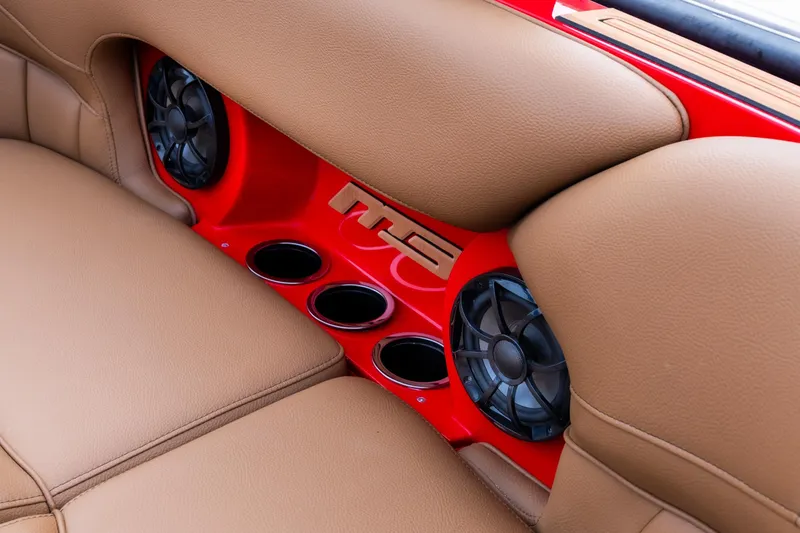 Slide: The Image of 2026 MB B52 23 Classic boat interior with tan leather seats and red accents at a marina. - 9