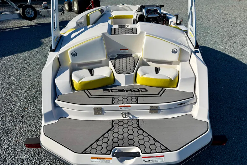 Slide: The Image of 2017 Scarab 165 G boat with yellow and white seating, hexagonal deck pattern. - 10