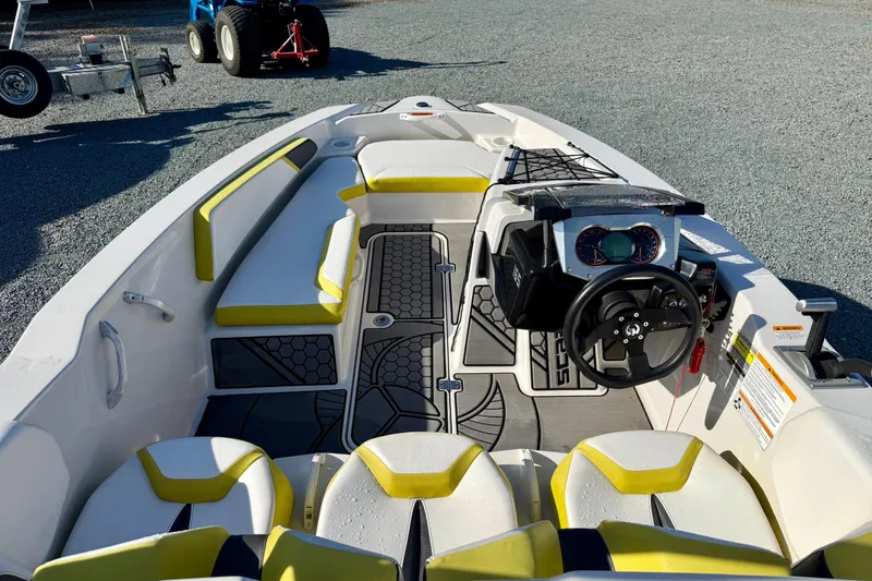 Slide: The Image of 2017 Scarab 165 G boat interior with yellow accents and modern dashboard. - 11