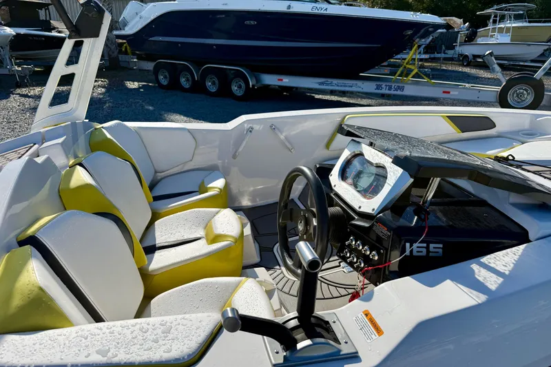 Slide: The Image of Interior of a 2017 Scarab 165 G boat with yellow and white seating. - 12