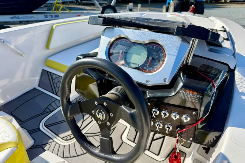 Slide: The Image of Steering console of a 2017 Scarab 165 G boat with gauges and controls. - 14