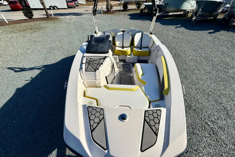 Slide: The Image of 2017 Scarab 165 G boat with yellow seating and modern design, parked outdoors. - 15
