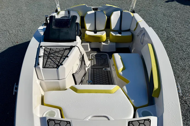 Slide: The Image of 2017 Scarab 165 G boat interior with yellow and white seating, net storage, and cup holders. - 16