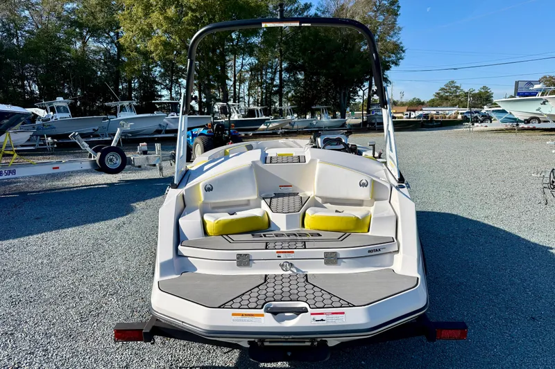 Slide: The Image of 2017 Scarab 165 G boat with yellow seating, parked on gravel lot. - 3