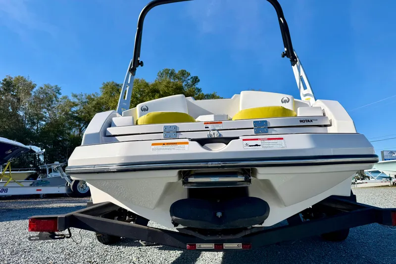 Slide: The Image of Rear view of a 2017 Scarab 165 G boat on a trailer, under clear blue sky. - 4