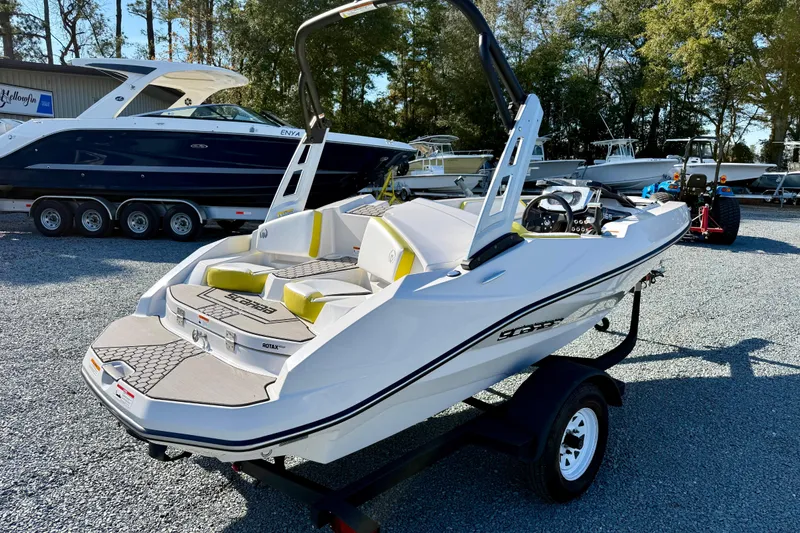Slide: The Image of 2017 Scarab 165 G boat on trailer, parked outdoors in a marina setting. - 5