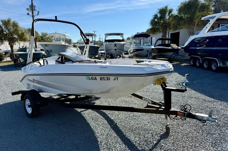 Slide: The Image of 2017 Scarab 165 G boat on trailer in marina with other boats. - 7