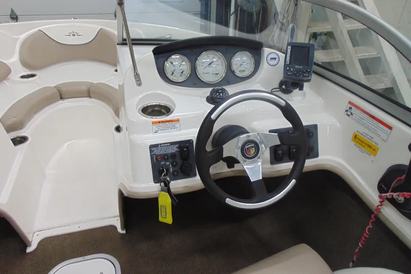 Slide: The Image of Interior of a 2011 Mariah R18.9 boat featuring steering wheel and dashboard controls. - 10