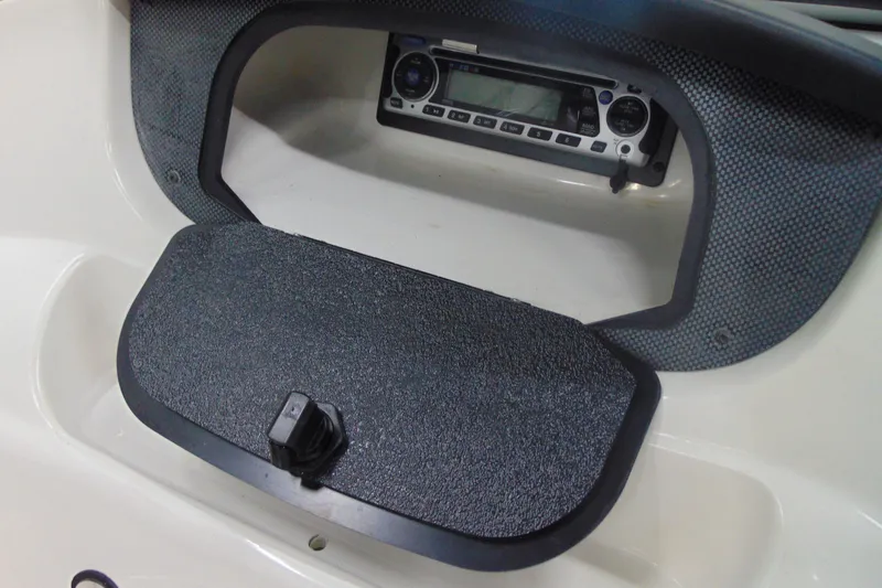 Slide: The Image of 2011 Mariah R18.9 boat dashboard with stereo system and storage compartment. - 15