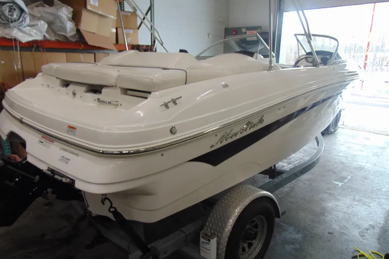 Slide: The Image of White 2011 Mariah R18.9 boat on trailer in garage setting. - 4