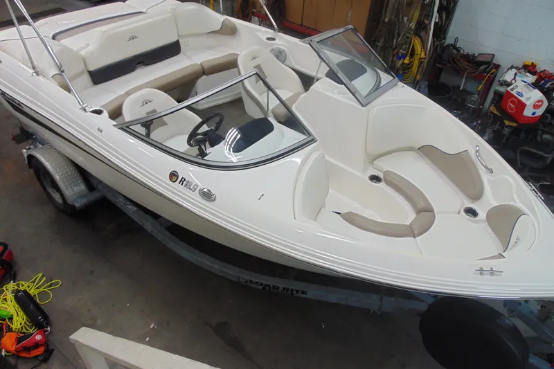 Slide: The Image of 2011 Mariah R18.9 boat on trailer in garage setting. - 5