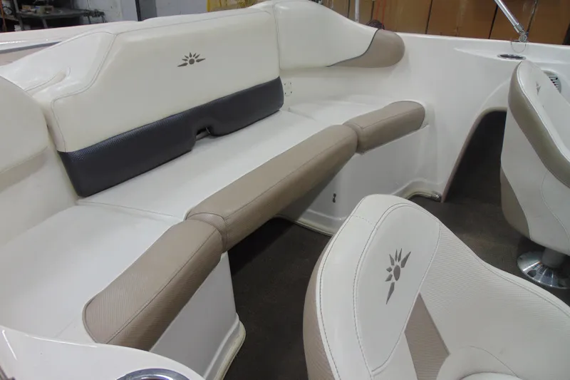 Slide: The Image of Interior of 2011 Mariah R18.9 boat with beige and white seating. - 7