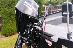 Slide: The Image of 2025 Tracker Super Guide V-16 T boat with Mercury outboard motor, parked outdoors. - 4