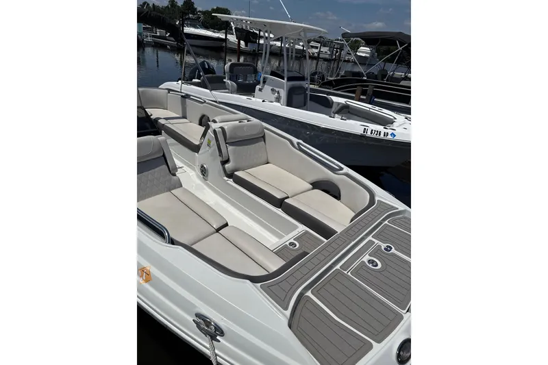 Slide: The Image of 2024 Crownline Eclipse E230 XS boat with spacious seating and sleek design. - 5