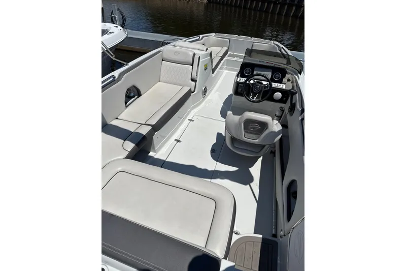 Slide: The Image of 2024 Crownline Eclipse E230 XS boat interior with modern seating and steering console. - 6