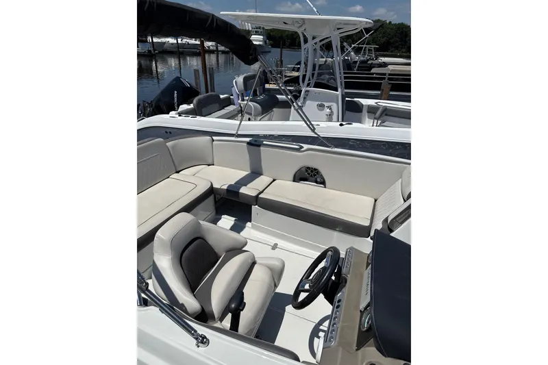 Slide: The Image of 2024 Crownline Eclipse E230 XS boat interior with seating and steering wheel. - 7