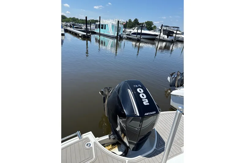 Slide: The Image of 2024 Crownline Eclipse E230 XS with Mercury 200 outboard at marina dock. - 9