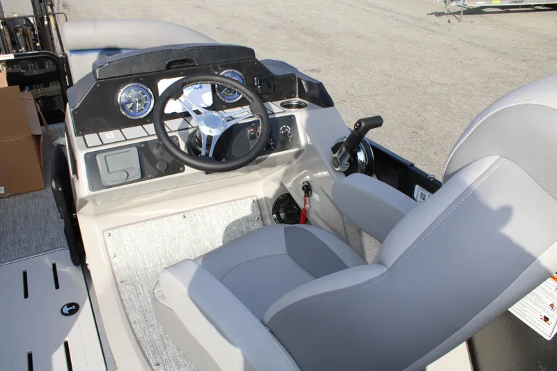 Slide: The Image of 2026 Premier 210 Sunsation RE XSD boat cockpit with steering wheel and controls. - 5