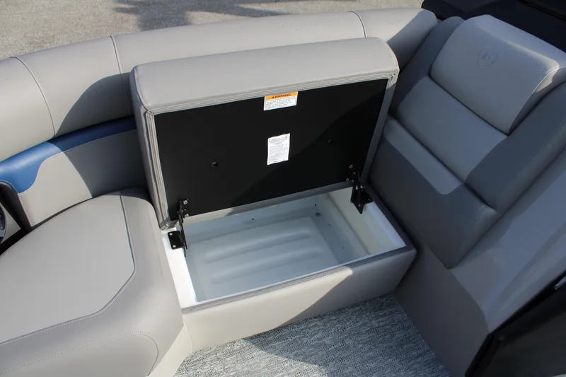 Slide: The Image of 2026 Premier 210 Sunsation RE XSD boat seat storage compartment open, showcasing interior space. - 7