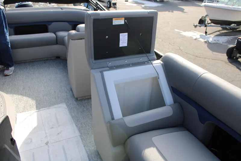 Slide: The Image of 2026 Premier 210 Sunsation RE XSD boat interior with open storage compartment. - 9