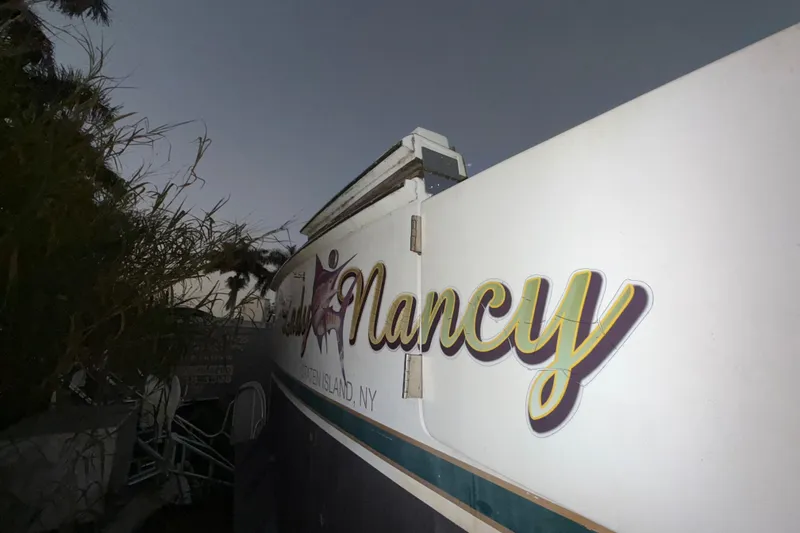 Slide: The Image of 1995 Bertram 46 Moppie boat with "Nancy" lettering. - 16