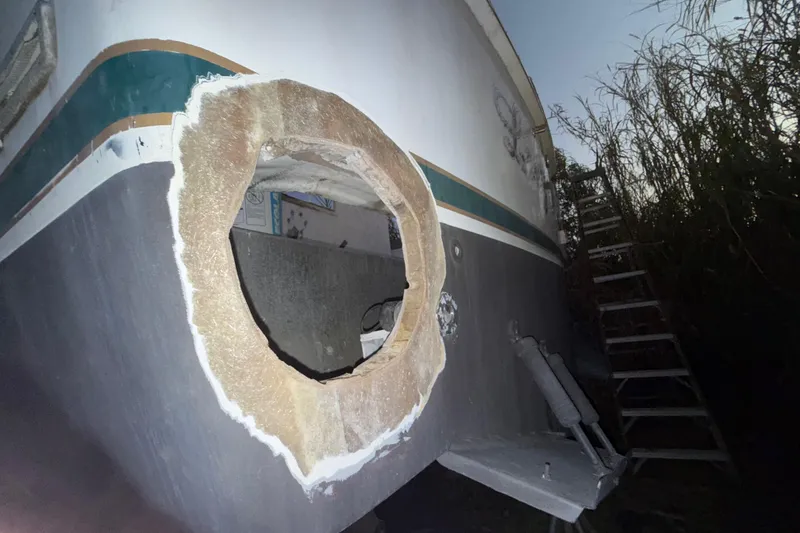 Slide: The Image of Damaged hull of a 1995 Bertram 46 Moppie boat with a large hole. - 21