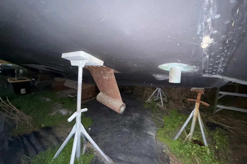 Slide: The Image of Bottom view of a 1995 Bertram 46 Moppie boat on stands, showing hull details. - 22