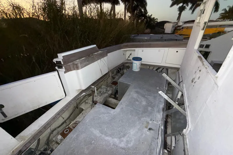 Slide: The Image of 1995 Bertram 46 Moppie boat interior, showing worn surfaces and storage compartments. - 35