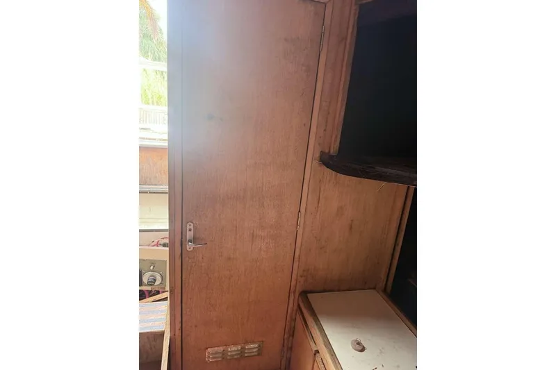 Slide: The Image of Interior of 1995 Bertram 46 Moppie boat with wooden door and cabinetry. - 4