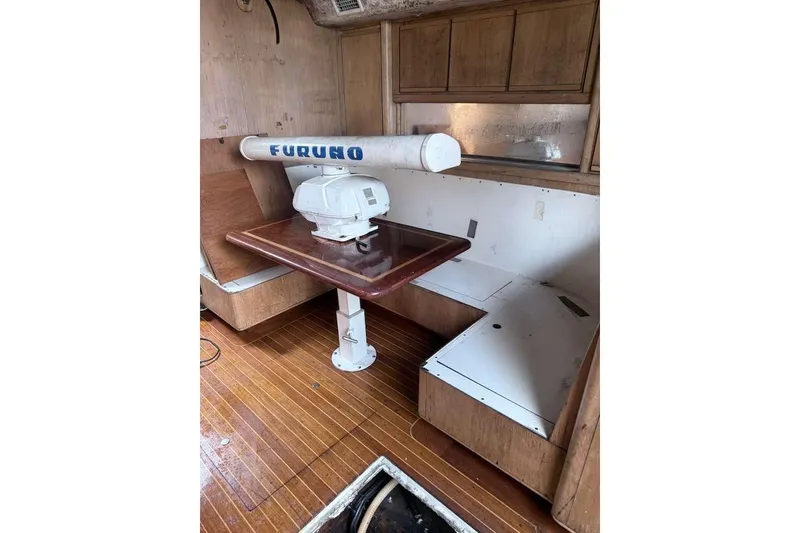 Slide: The Image of 1995 Bertram 46 Moppie interior with wooden flooring and Furuno radar equipment. - 5
