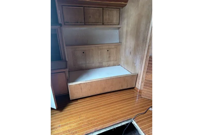 Slide: The Image of Interior of 1995 Bertram 46 Moppie boat with wooden cabinetry and flooring. - 8