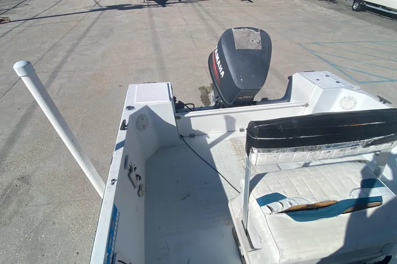 Slide: The Image of 1999 Pro Sports 1850 CC boat with Yamaha outboard motor, docked on concrete. - 14