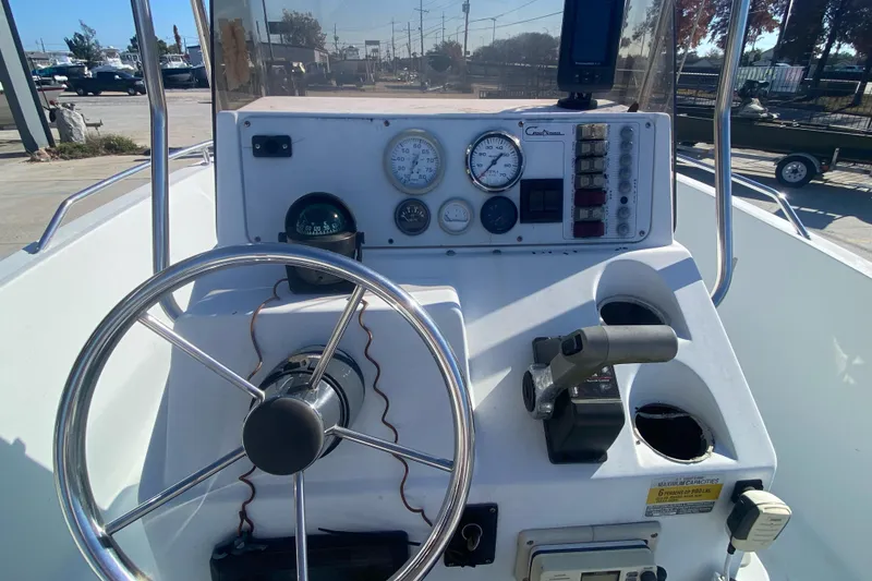 Slide: The Image of 1999 Pro Sports 1850 CC boat console with steering wheel and gauges. - 17