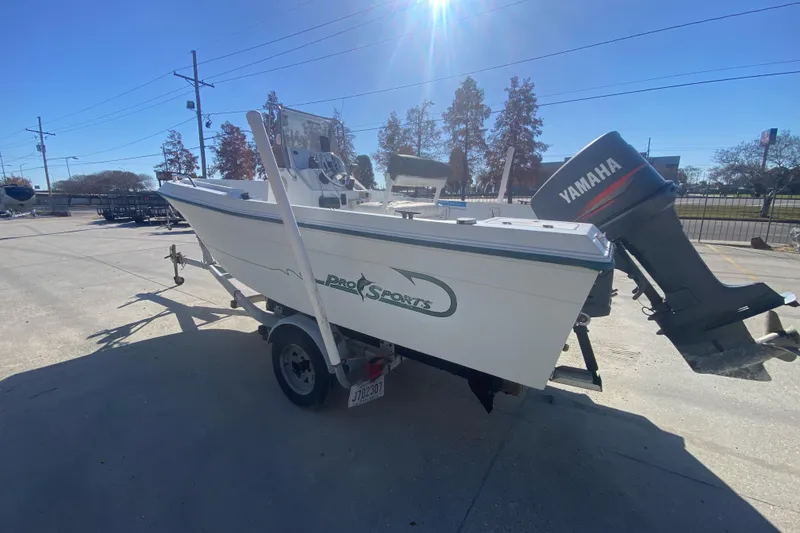 Slide: The Image of 1999 Pro Sports 1850 CC boat with Yamaha outboard motor on a trailer. - 4