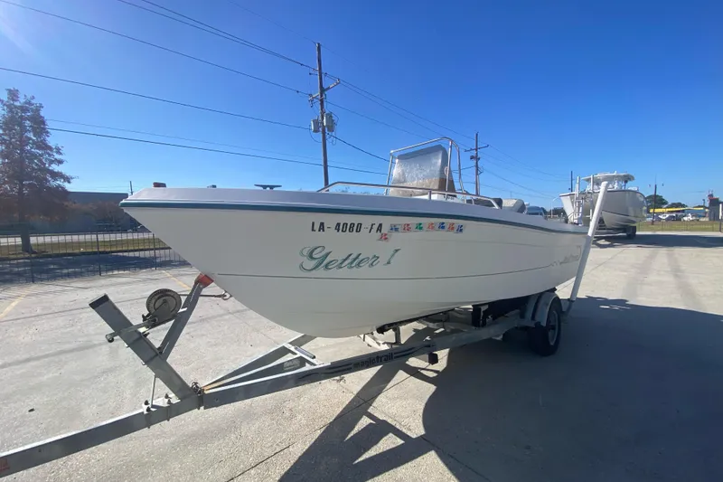 Slide: The Image of 1999 Pro Sports 1850 CC boat on trailer under clear blue sky. - 6