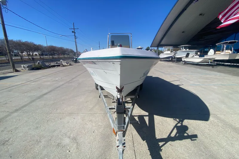 Slide: The Image of 1999 Pro Sports 1850 CC boat on trailer, parked outdoors under clear blue sky. - 7