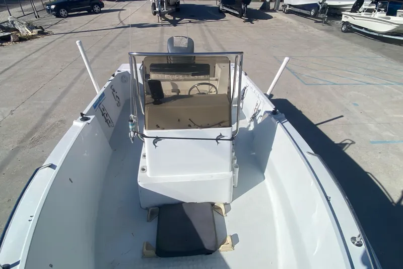 Slide: The Image of 1999 Pro Sports 1850 CC boat, white, center console, parked in a marina. - 9