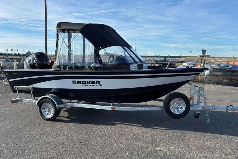 The Image of 2026 Smoker Craft Osprey 172 boat on trailer, black canopy, outdoor setting. - 0