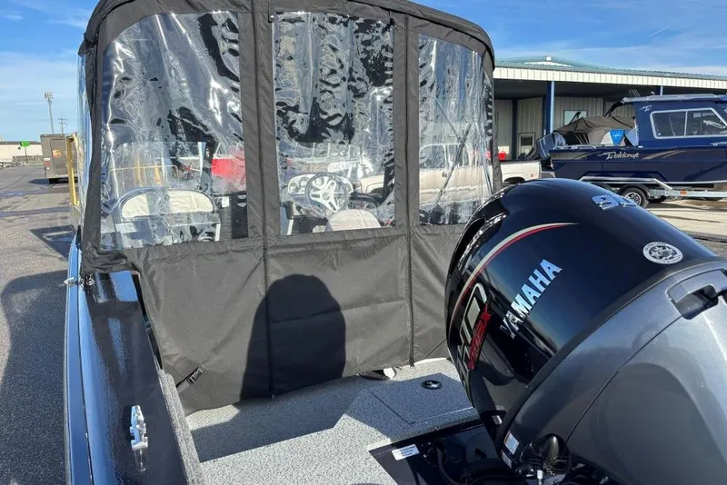 Slide: The Image of 2026 Smoker Craft Osprey 172 boat with Yamaha outboard motor and protective canopy. - 2