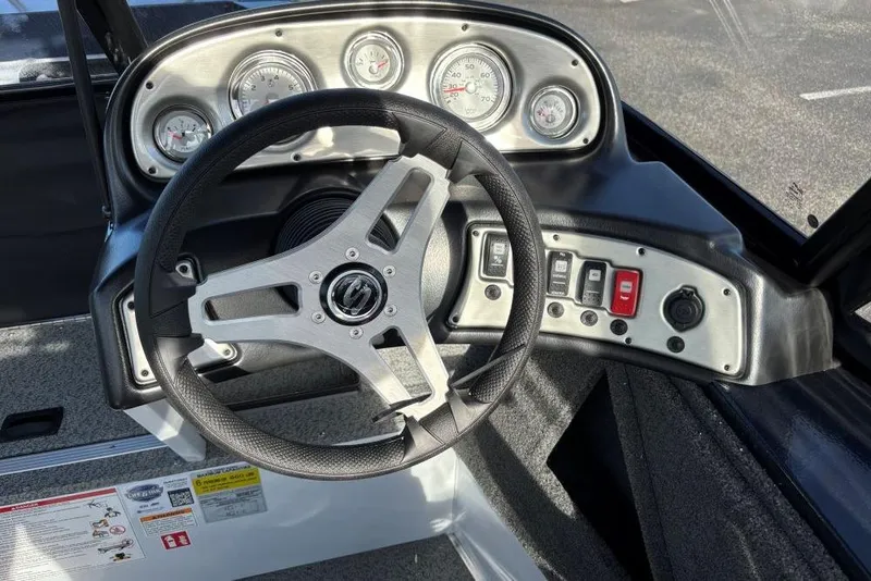 Slide: The Image of 2026 Smoker Craft Osprey 172 dashboard with steering wheel and gauges. - 4