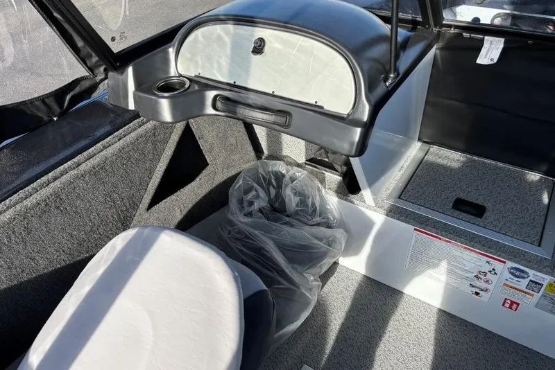 Slide: The Image of Interior of 2026 Smoker Craft Osprey 172 boat, featuring seating and storage compartments. - 5