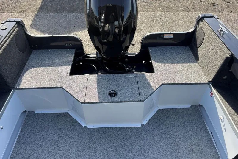 Slide: The Image of 2026 Smoker Craft Osprey 172 boat interior with motor, gray carpeted deck. - 7