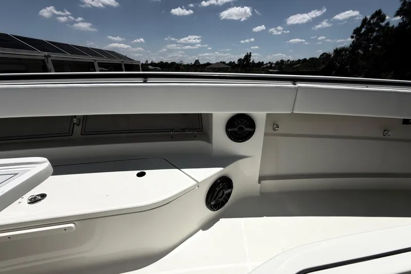 Slide: The Image of 2017 HCB 42 Siesta boat interior with seating and speakers under a sunny sky. - 57